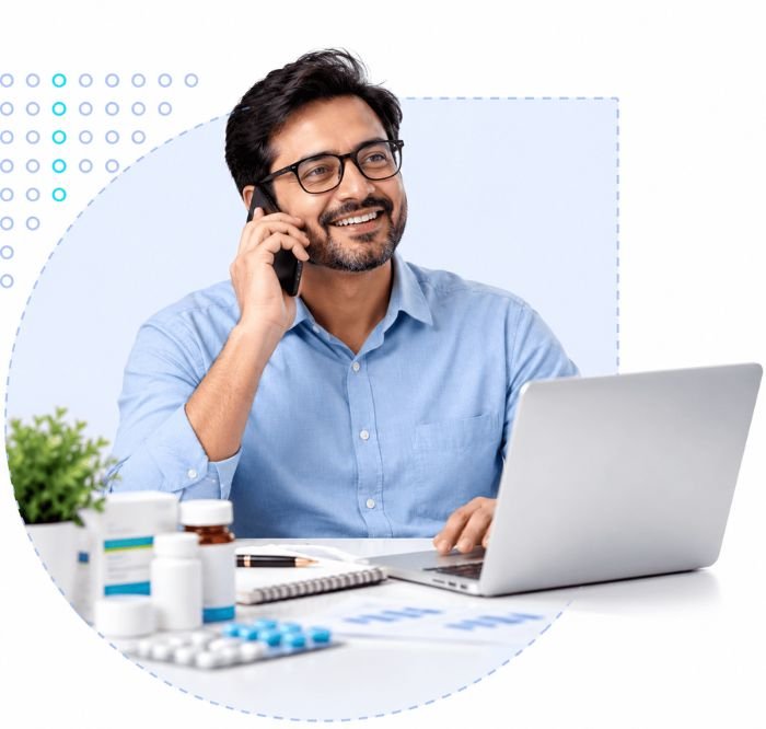 Pharmacy Growth India_ smiling proffesional consultant on phone and laptop with medicines, helping independent chemists grow their pharmacy business